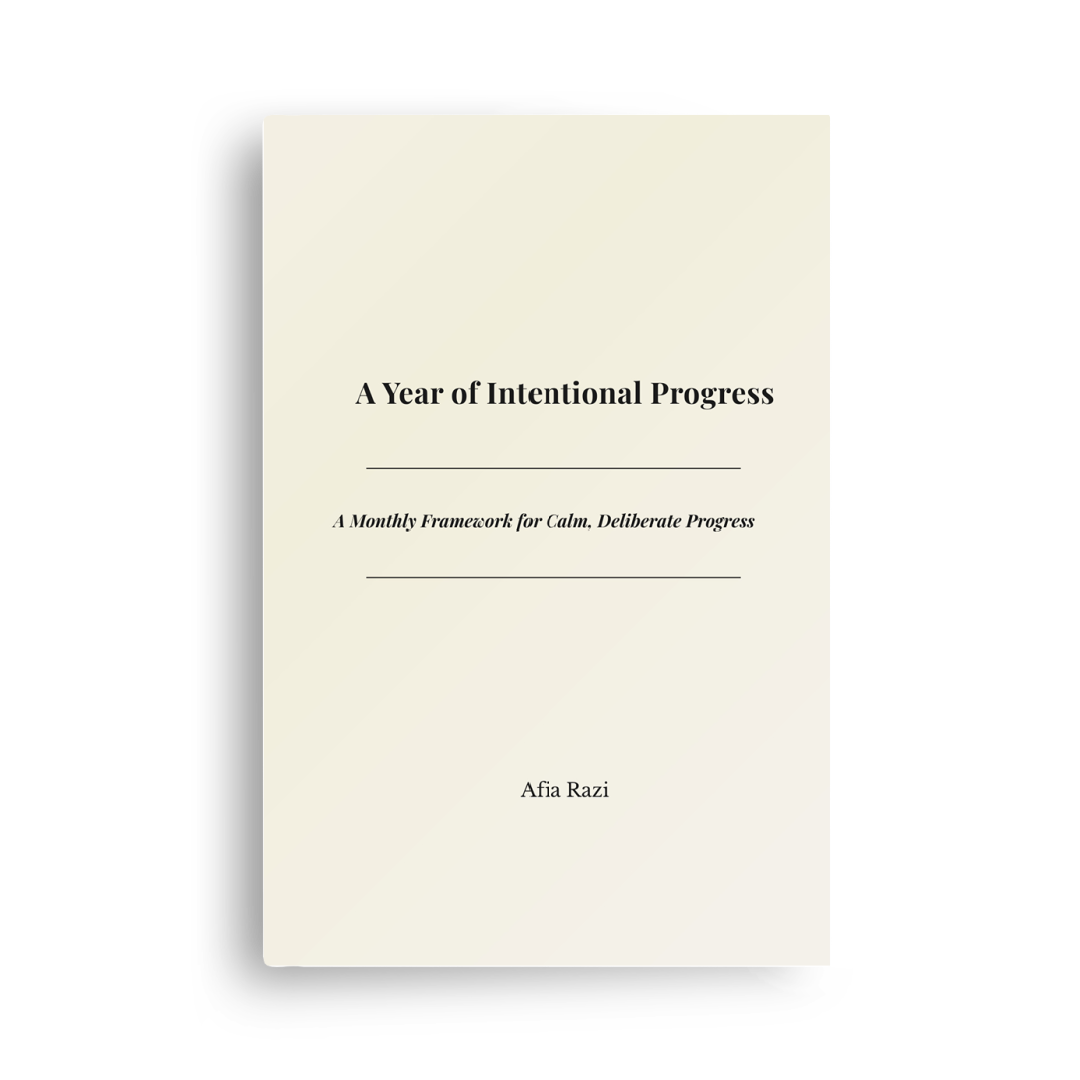 Book cover of A Year of Intentional Progress by Afia Razi, a monthly planning and productivity journal