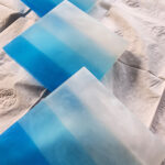 Decorative drink coasters are placed on a tabletop.