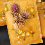 Handmade soap bar with dried flowers and herbs embedded.
