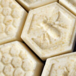 Handmade soap bars shaped like honeycomb and bees.