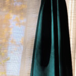 Sunlight filtering through a curtain creating a soft silhouette and textured light pattern.