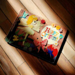 Sunlight falling diagonally across a handmade origami book on a wooden floor, creating soft shadows and contrast