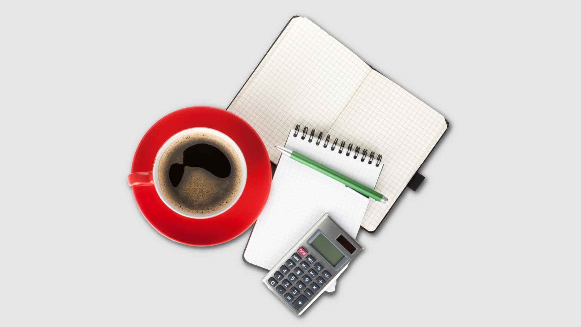 Top view of a notebook, calculator, and coffee on a desk showing a simple decision-making setup