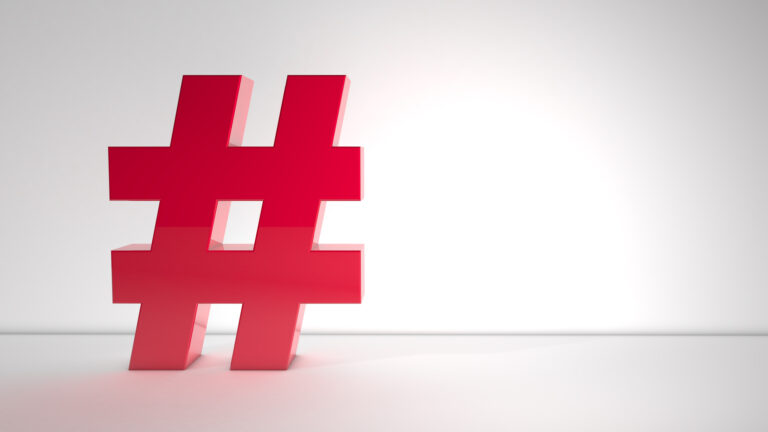 Large red hashtag (#) symbol on a clean white background representing hashtags, social media, and digital communication.