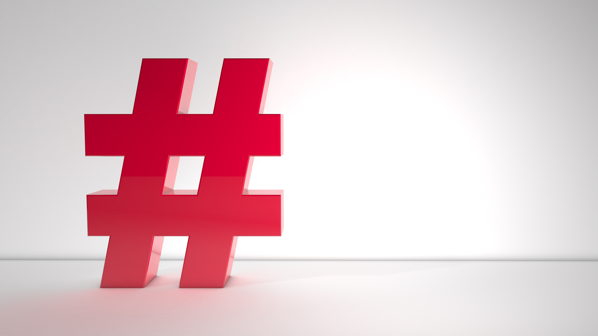 Large red hashtag (#) symbol on a clean white background representing hashtags, social media, and digital communication.